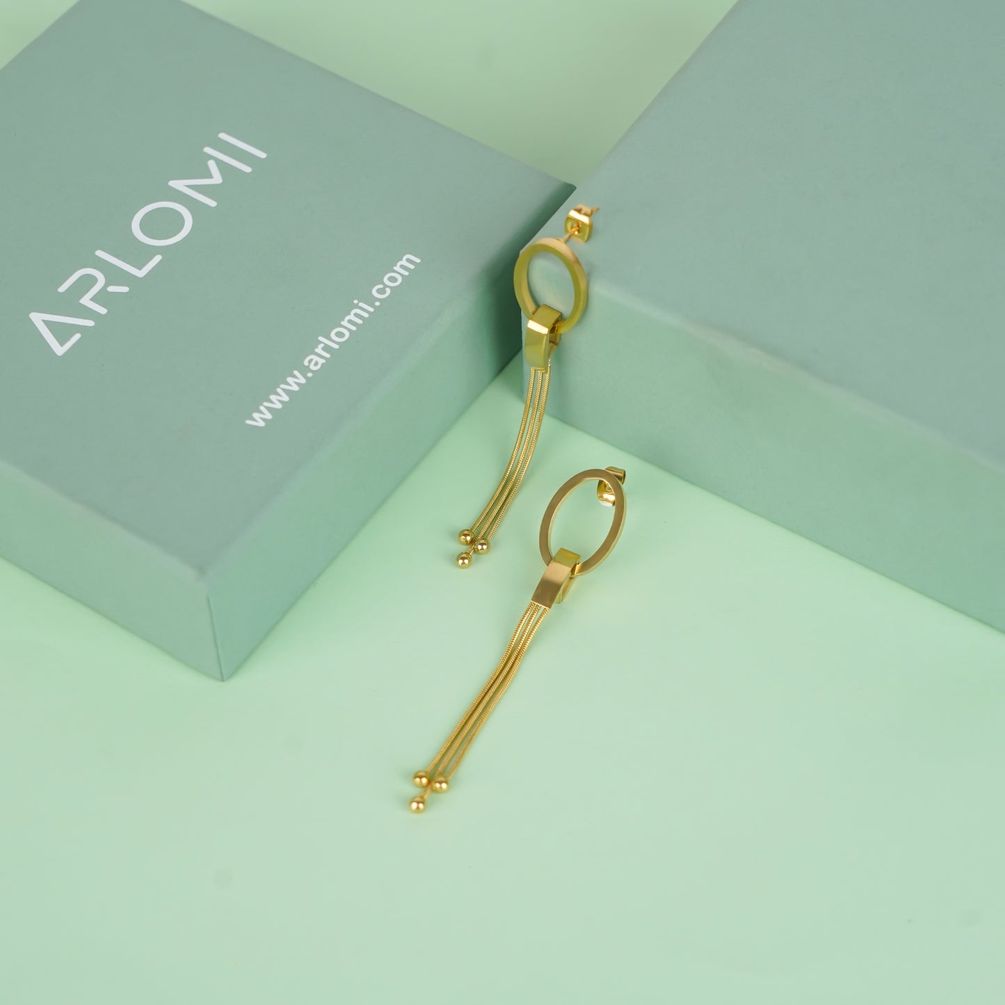 Gold oval drop earrings with chain tassels